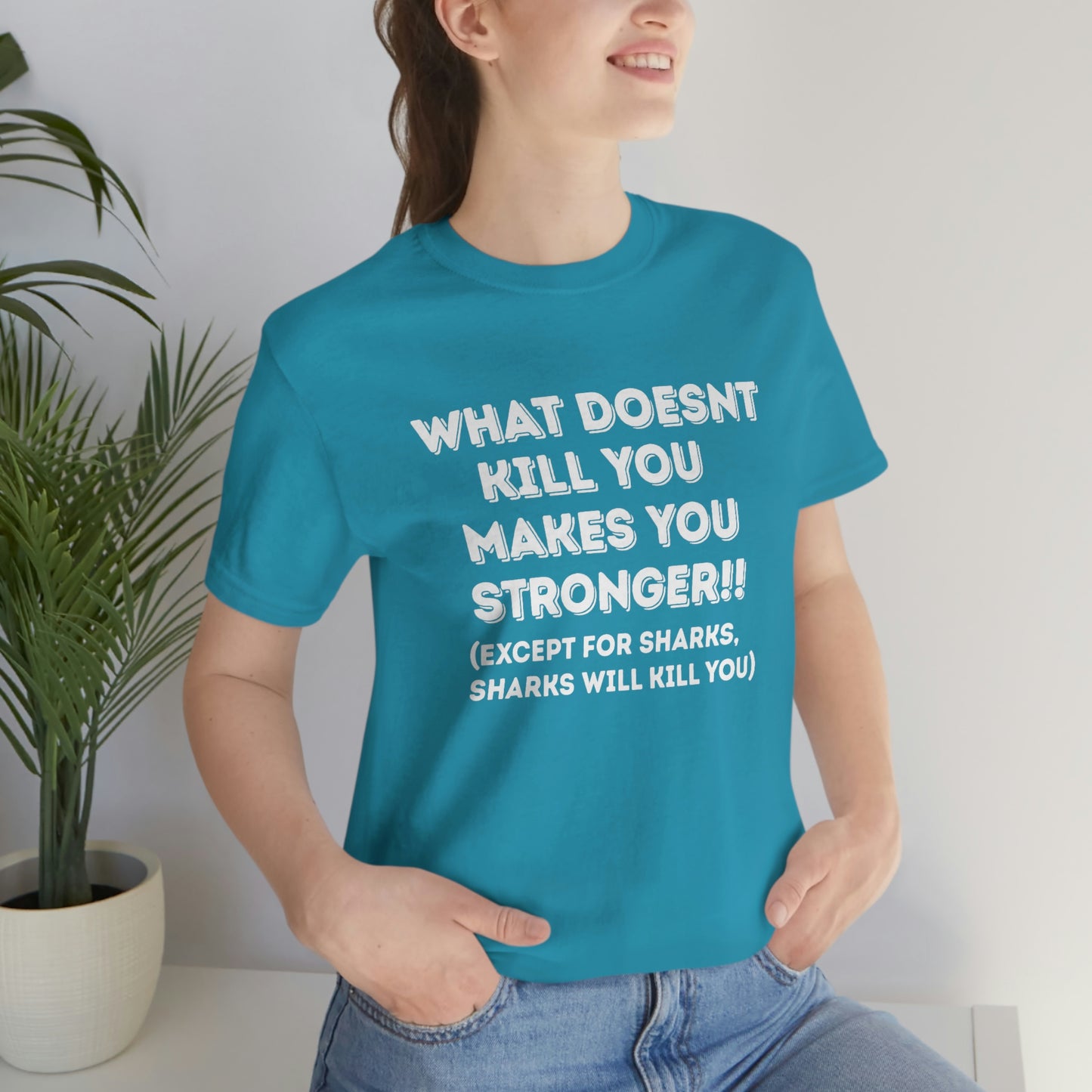 "What doesn't kill you makes you stronger, except sharks, sharks will kill you" - Regular Cotton - Unisex Jersey Short Sleeve Tee (Bella+Canvas 3001)